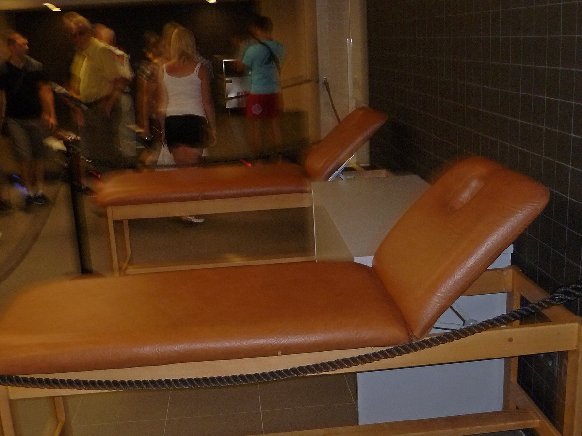 Massage therapist with client in tropical setting
