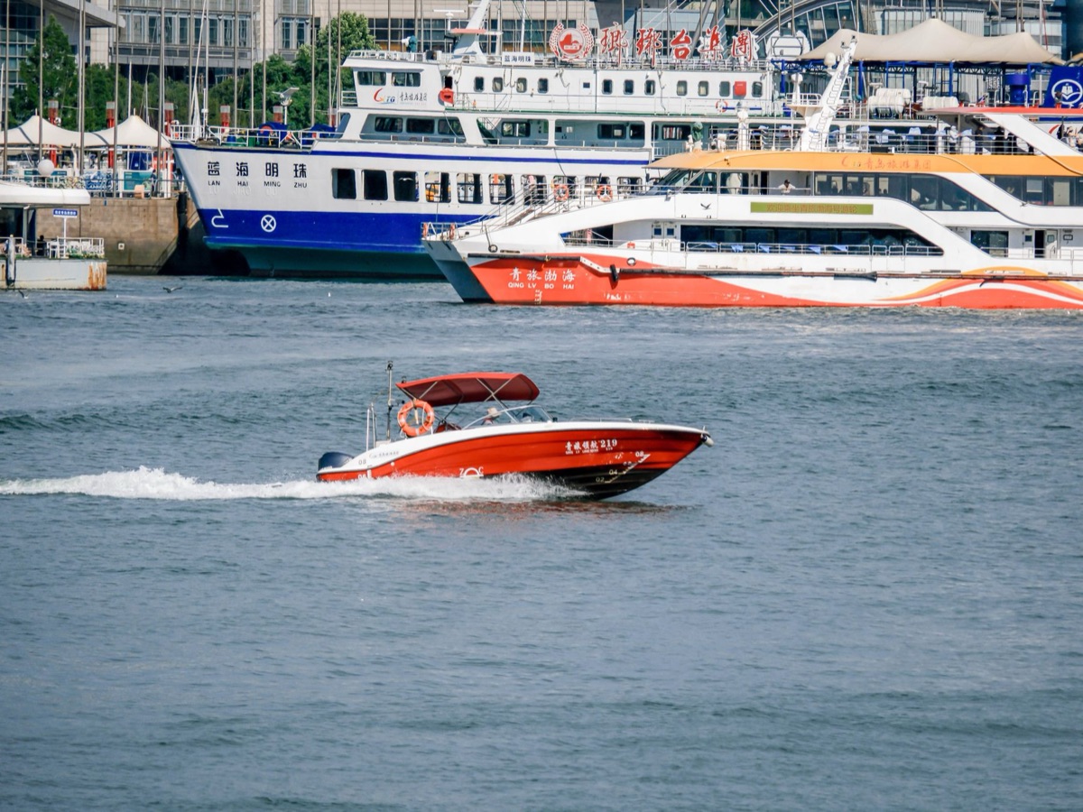 speedboat and cruise ship side by side