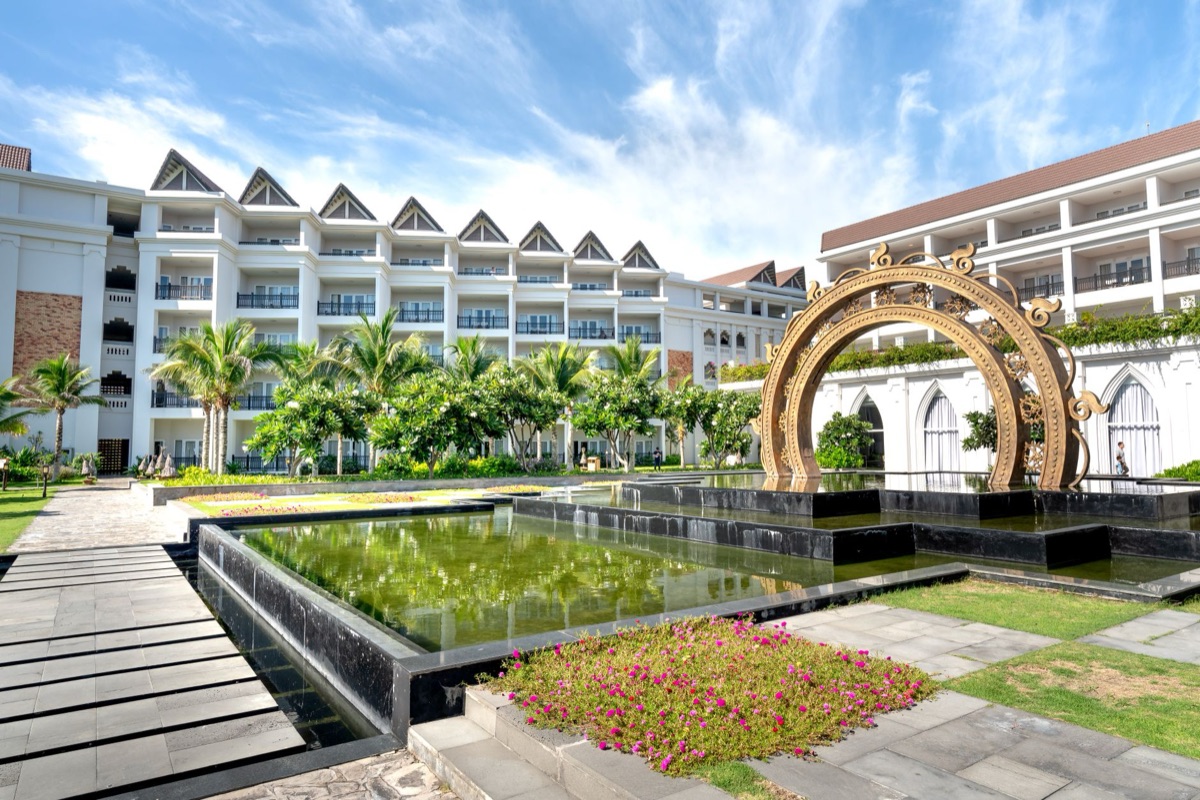 Entrance of a tropical resort with palm trees