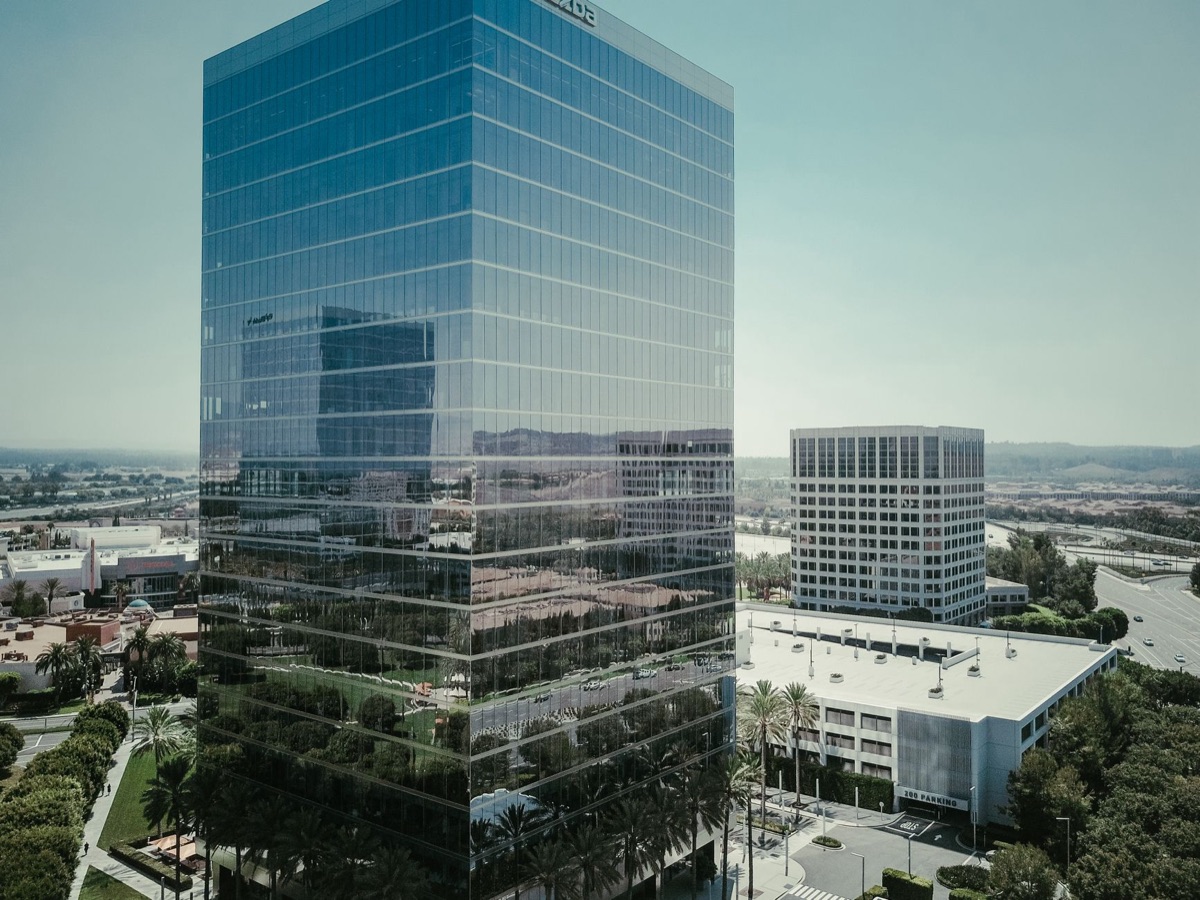 Towering building with glass facade in tropical setting